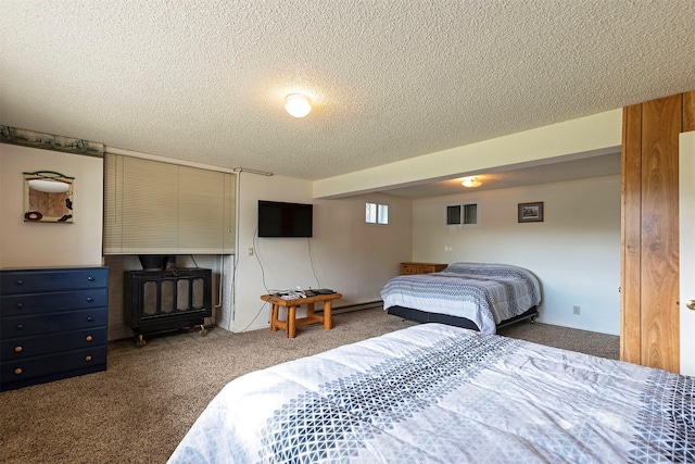 bedroom featuring a textured ceiling and carpet flooring