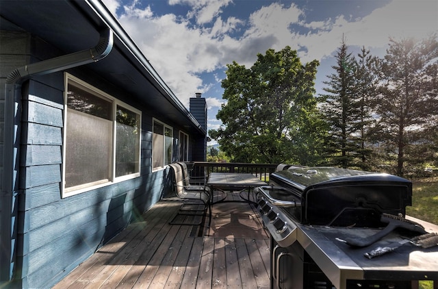 wooden terrace with a grill