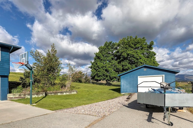 view of yard with an outbuilding and a detached garage