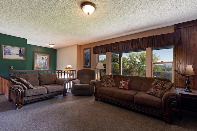 living room with carpet flooring, a wealth of natural light, and a textured ceiling