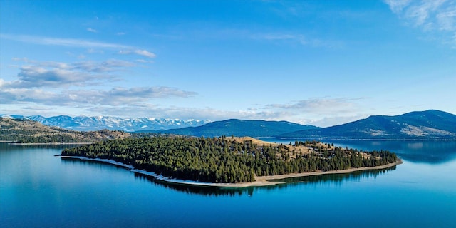 drone / aerial view featuring a water and mountain view