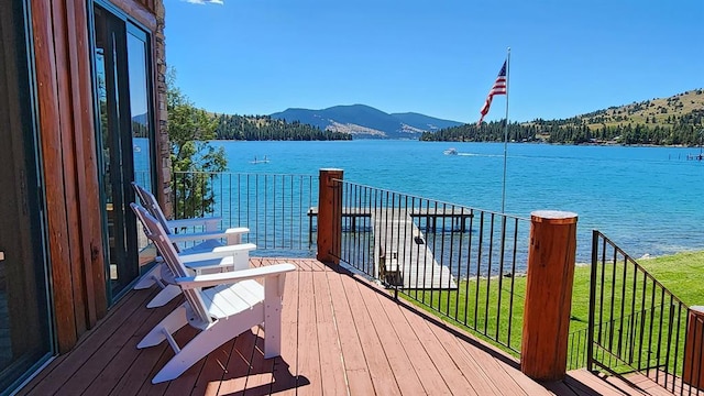 wooden terrace featuring a water and mountain view