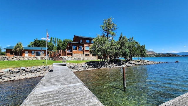 view of dock featuring a yard and a water view