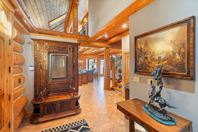 interior space with rustic walls, vaulted ceiling with beams, stairs, and wood ceiling