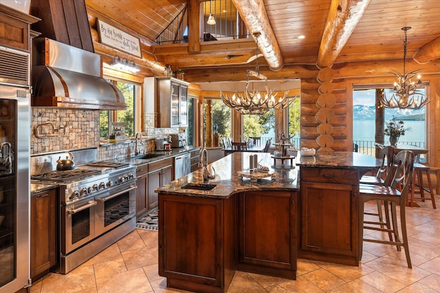 kitchen featuring a center island, extractor fan, high quality appliances, an inviting chandelier, and a sink