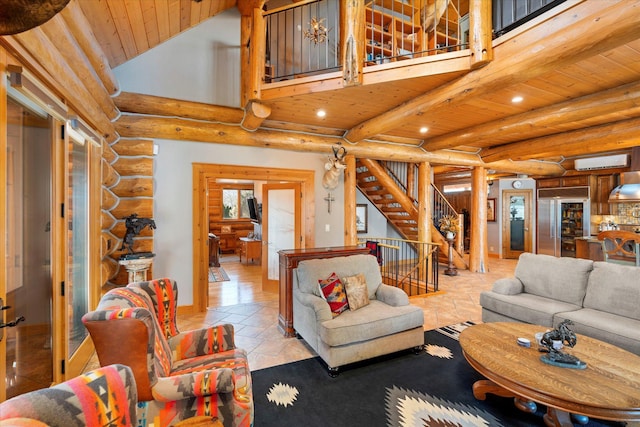 living area with beamed ceiling, high vaulted ceiling, an AC wall unit, stairway, and wooden ceiling