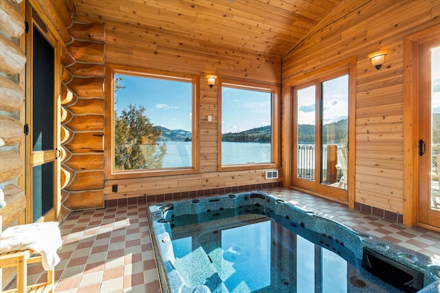 view of pool with an indoor hot tub