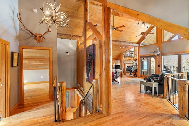 corridor featuring high vaulted ceiling, wood ceiling, wood-type flooring, beamed ceiling, and an upstairs landing