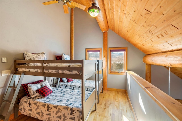 bedroom with hardwood / wood-style flooring, wood ceiling, baseboards, and vaulted ceiling