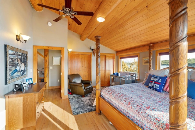 bedroom with two closets, beam ceiling, wooden ceiling, hardwood / wood-style flooring, and high vaulted ceiling