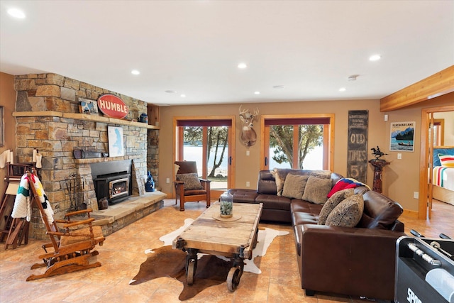 living room with a stone fireplace and recessed lighting