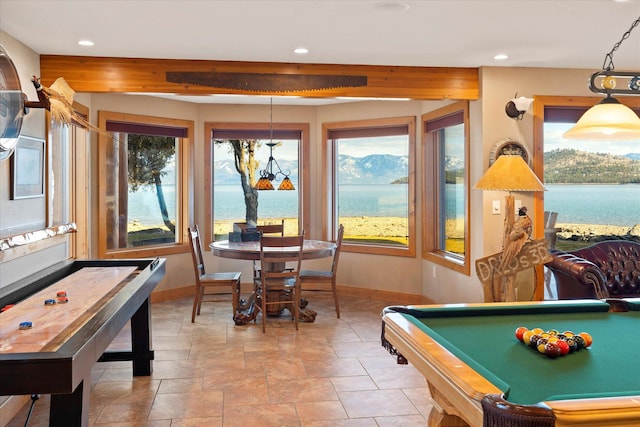 recreation room featuring recessed lighting, baseboards, and a water view