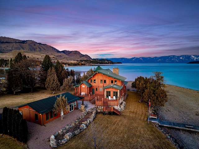 drone / aerial view featuring a water and mountain view