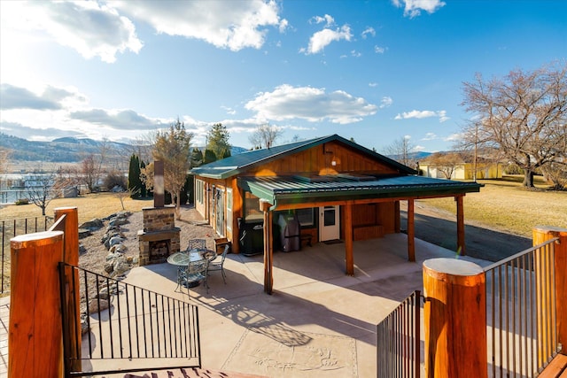 view of patio / terrace featuring area for grilling, fence, and a mountain view