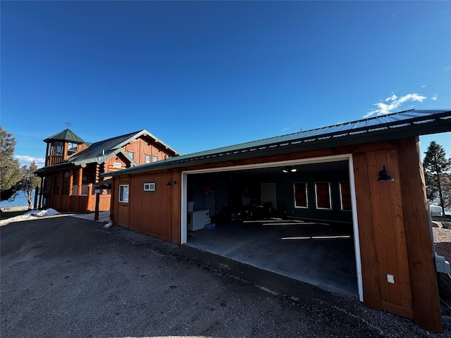 view of side of property with metal roof and a garage