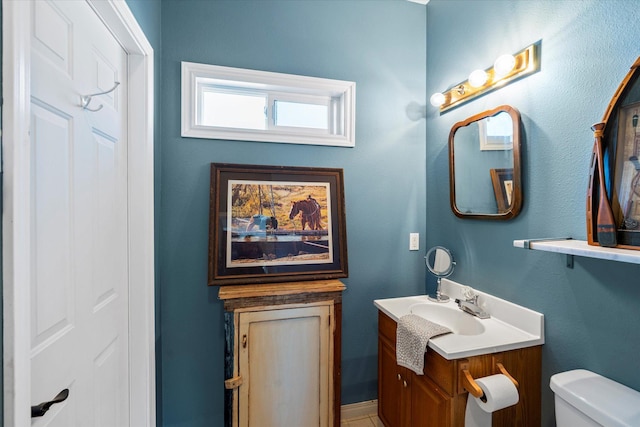 bathroom with toilet and vanity