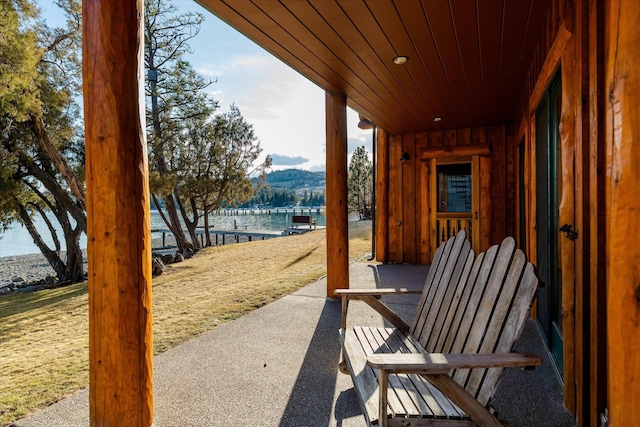 view of patio / terrace with a water and mountain view