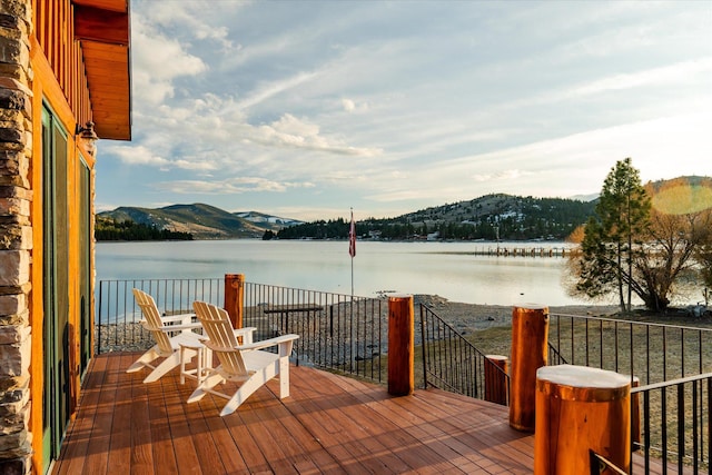 deck with a water and mountain view