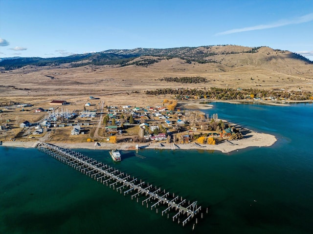 birds eye view of property with a water and mountain view