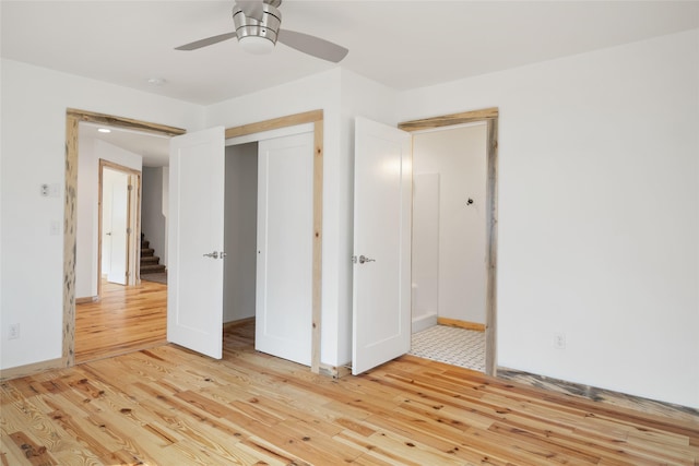 unfurnished bedroom with a closet, baseboards, light wood-style floors, and a ceiling fan