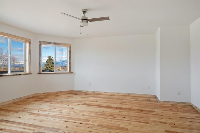 unfurnished room with hardwood / wood-style floors and ceiling fan