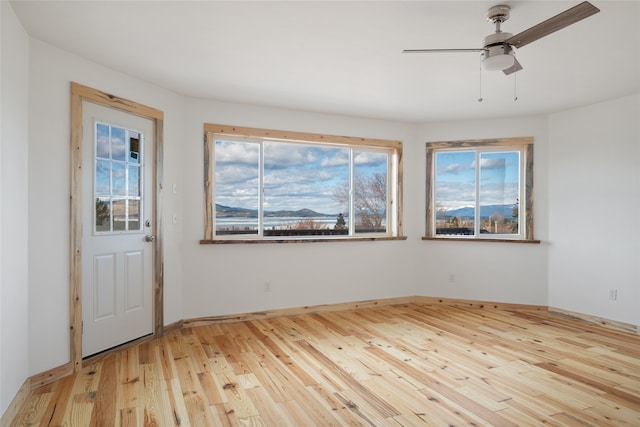 entryway featuring light wood-type flooring and a ceiling fan