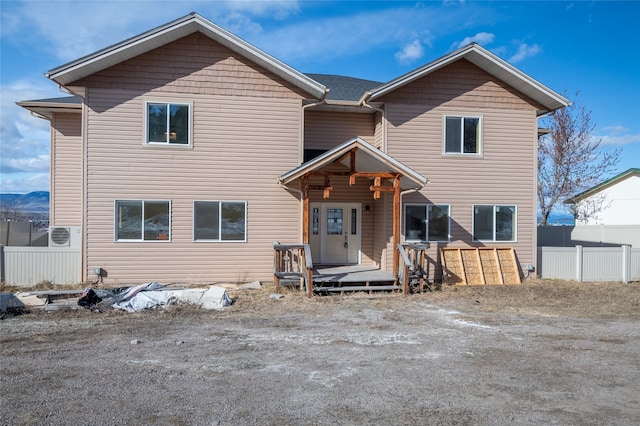 view of front facade featuring a deck and fence