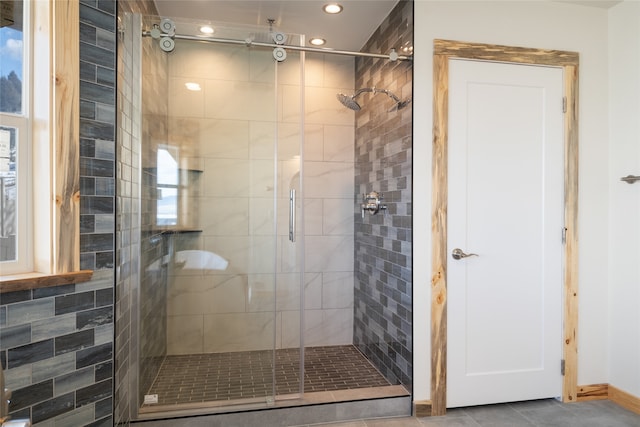 bathroom featuring recessed lighting, a stall shower, and tile patterned flooring