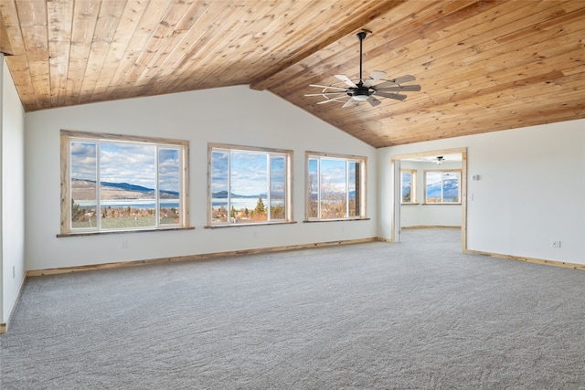 empty room featuring baseboards, carpet, wood ceiling, vaulted ceiling, and a ceiling fan