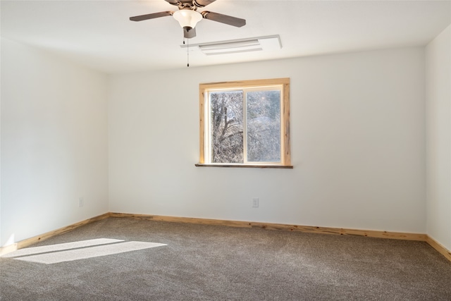 carpeted empty room with a ceiling fan and baseboards