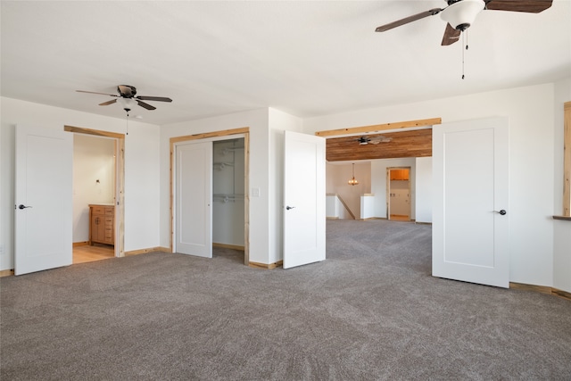 unfurnished bedroom featuring a closet, baseboards, and carpet floors