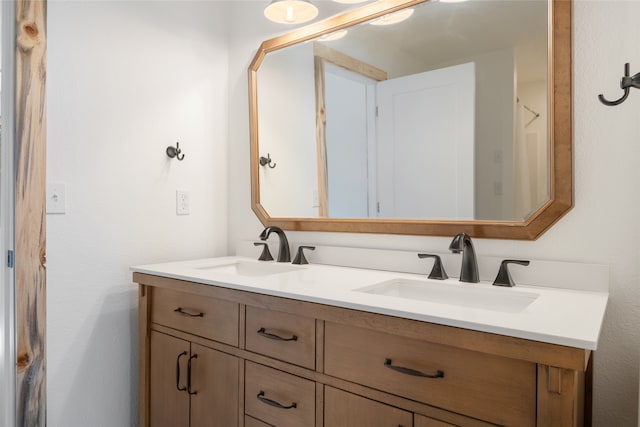 full bath featuring a sink and double vanity