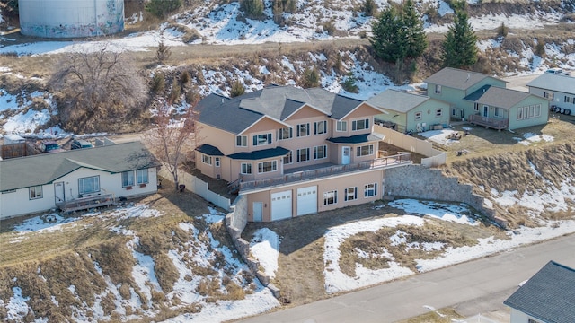 snowy aerial view with a residential view