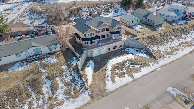 snowy aerial view featuring a residential view