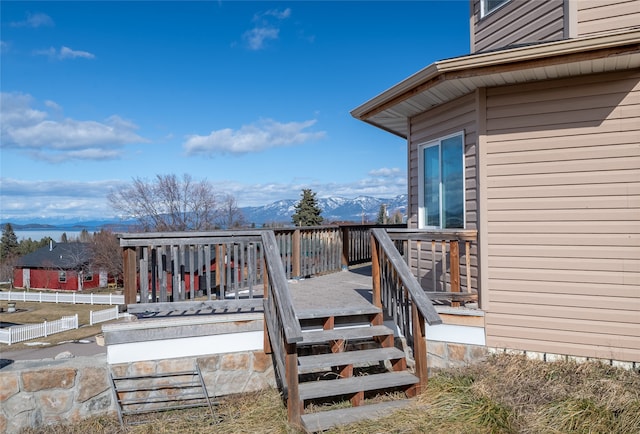 wooden deck featuring a mountain view and fence