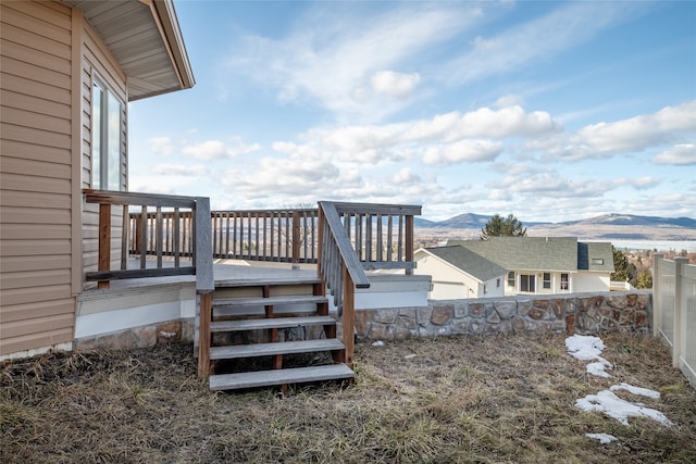 exterior space with a deck with mountain view and fence