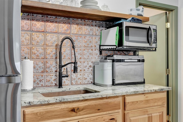 1081 Old Barn Rd, Seeley Lake, MT 59868 - kitchen with stainless steel appliances, light stone countertops, and tasteful backsplash