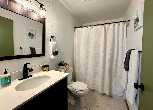 full bath with vanity, a textured ceiling, tile patterned floors, toilet, and a textured wall