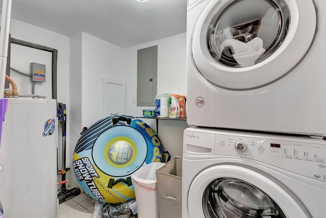 1081 Old Barn Rd, Seeley Lake, MT 59868 - washroom featuring stacked washing machine and dryer, electric panel, gas water heater, and tile patterned floors