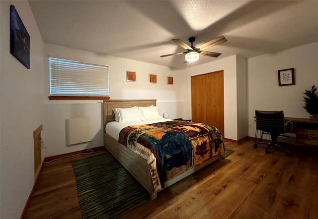 bedroom featuring a closet, a ceiling fan, and wood finished floors