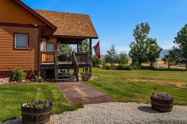 view of yard featuring a deck and stairs