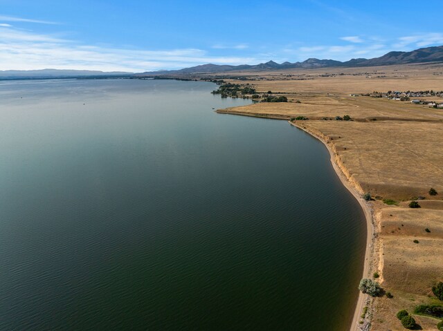 aerial view featuring a water and mountain view