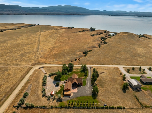 birds eye view of property featuring a water and mountain view