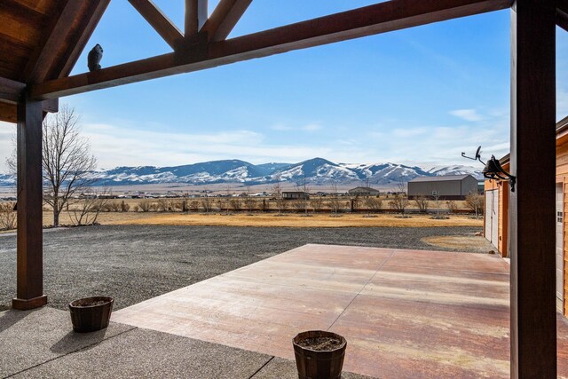 view of patio featuring a rural view and a mountain view