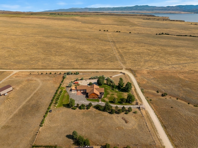 aerial view with a water and mountain view and a rural view
