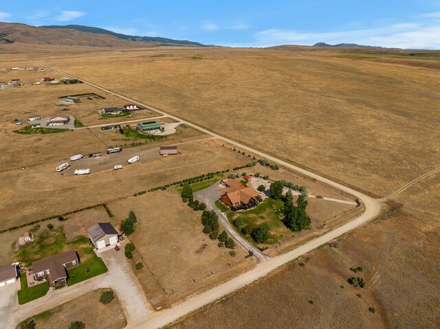 birds eye view of property featuring a mountain view and a rural view