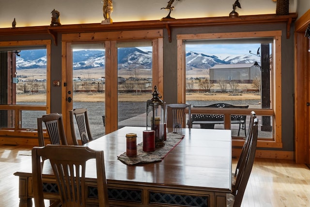 dining space featuring a mountain view and light wood finished floors