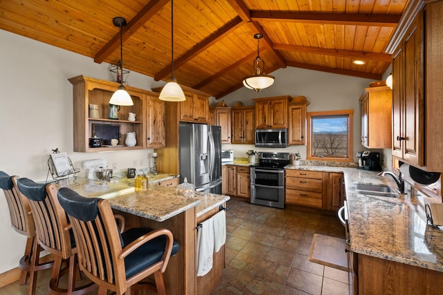 kitchen with a sink, stainless steel appliances, a peninsula, and brown cabinetry