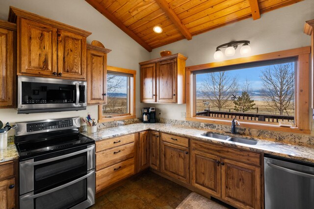 kitchen with wood ceiling, lofted ceiling with beams, light stone counters, appliances with stainless steel finishes, and a sink