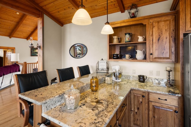 kitchen with pendant lighting, lofted ceiling with beams, wood finished floors, a peninsula, and wooden ceiling